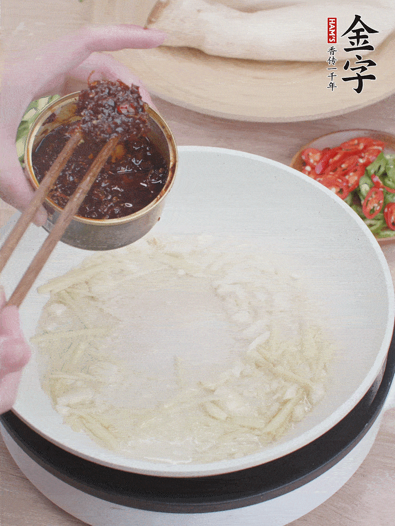起鍋熱油，姜蒜、金字火腿干貝醬煸香。